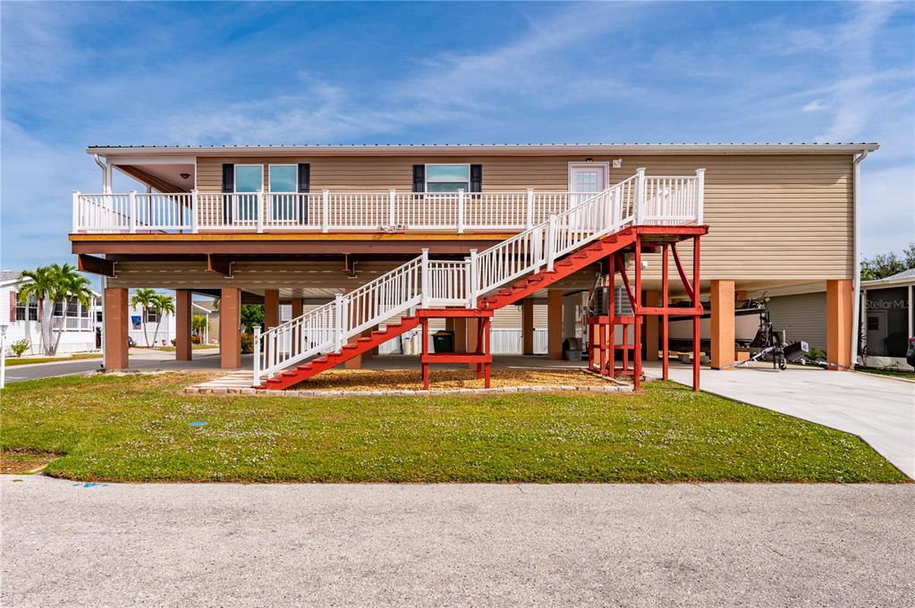 67 Windmill Boulevard Punta Gorda, FL 33950 - Photo 43 of 70 a view of a house with a small yard and sitting area