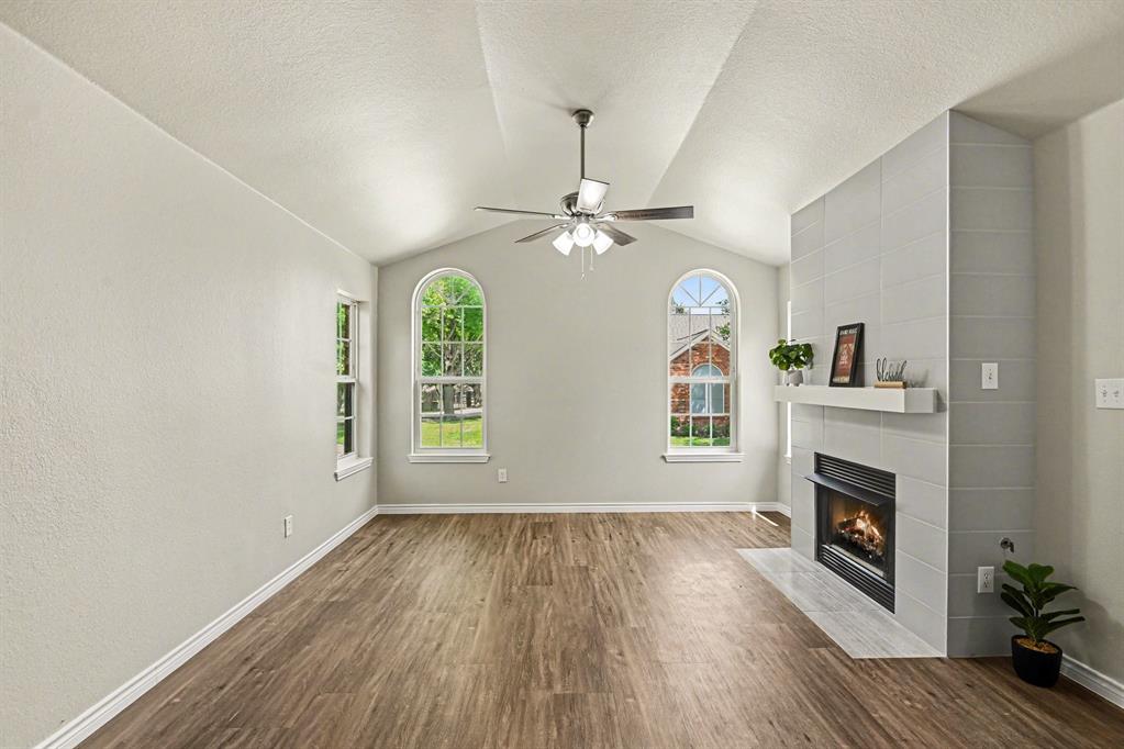 6113 Haley Lane Fort Worth, TX 76132 - Photo 9 of 38 Living room includes vaulted ceiling, gas fireplace, new flooring and new ceiling fan.