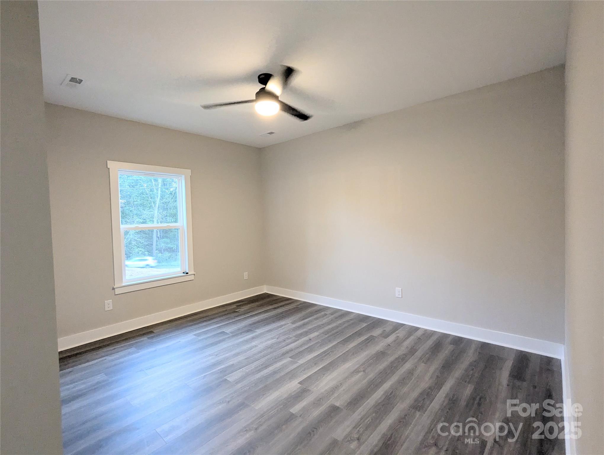 524 Waco Road Kings Mountain, NC 28086 - Photo 13 of 21 a view of an empty room with wooden floor and a window