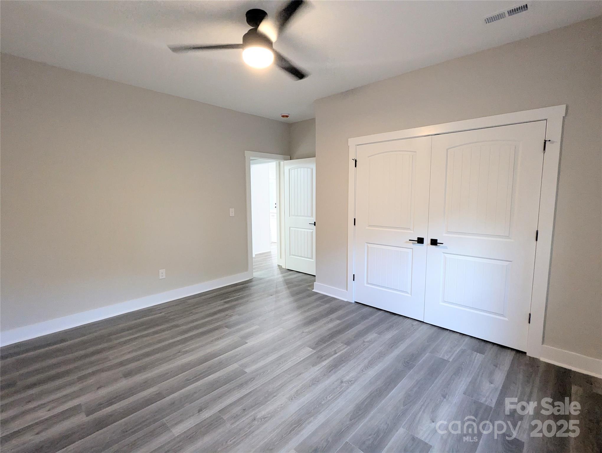 524 Waco Road Kings Mountain, NC 28086 - Photo 14 of 21 an empty room with wooden floor cabinet and windows