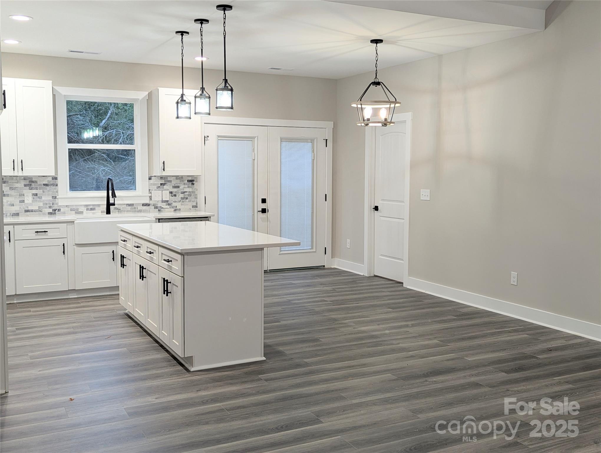 524 Waco Road Kings Mountain, NC 28086 - Photo 6 of 21 a large white kitchen with granite countertop a stove top oven a sink dishwasher and white cabinets with wooden floor
