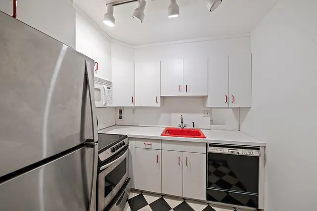 a kitchen with a sink stove and cabinets