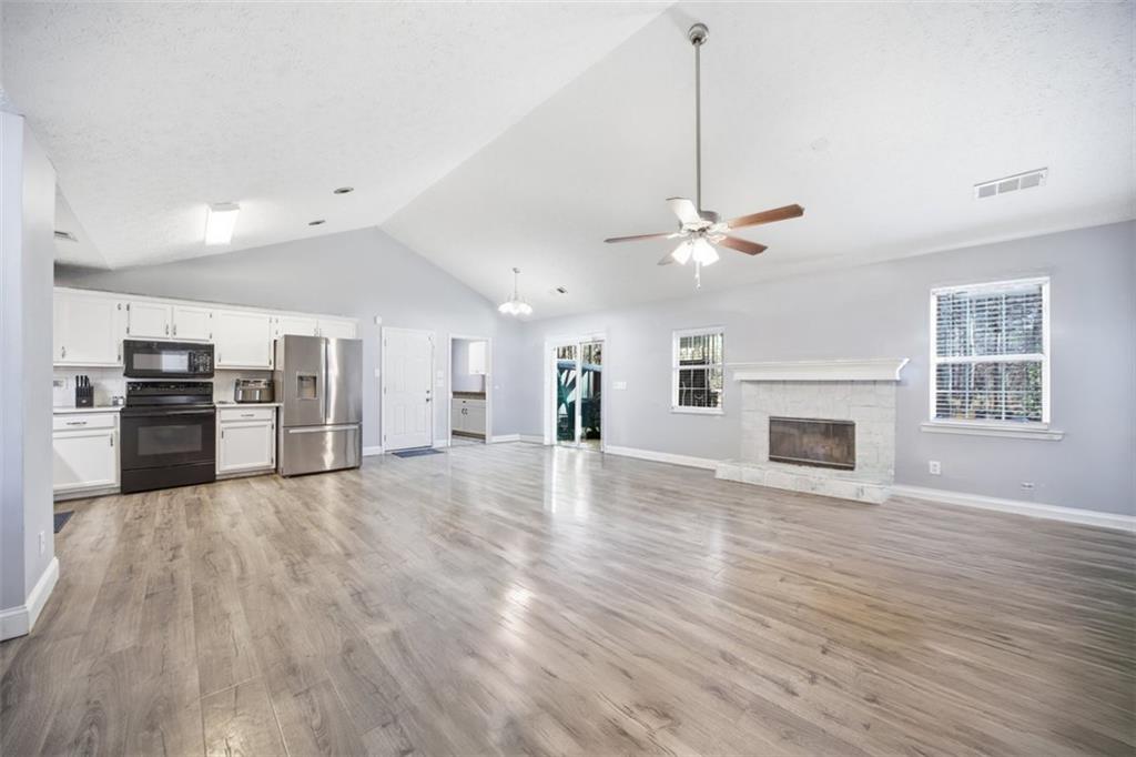 10 Stoneview Circle Covington, GA 30016 - Photo 12 of 25 a view of a kitchen with a stove cabinets and wooden floor