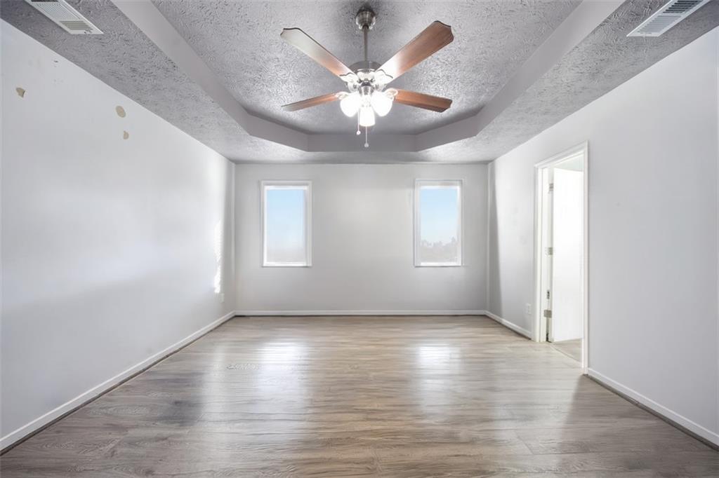 10 Stoneview Circle Covington, GA 30016 - Photo 18 of 25 a view of an empty room with wooden floor and a window