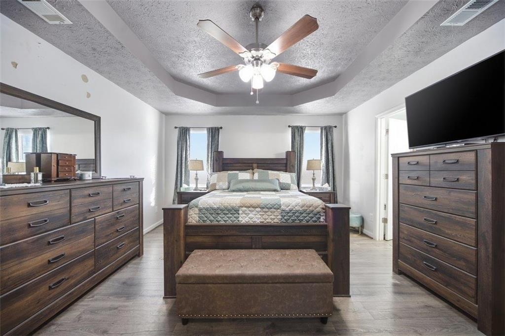 10 Stoneview Circle Covington, GA 30016 - Photo 19 of 25 a bedroom with a large bed and flat tv