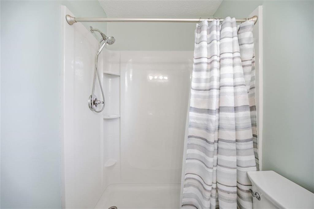 10 Stoneview Circle Covington, GA 30016 - Photo 23 of 25 a bathroom with a shower curtain