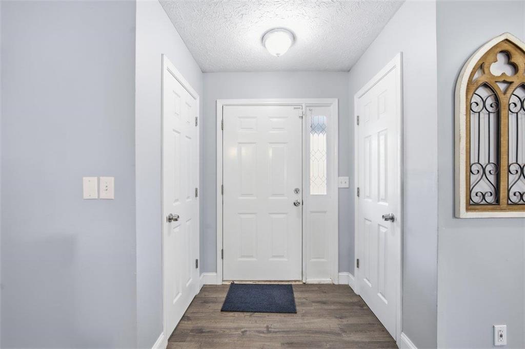 10 Stoneview Circle Covington, GA 30016 - Photo 5 of 25 a view of a hallway with wooden floor and closet