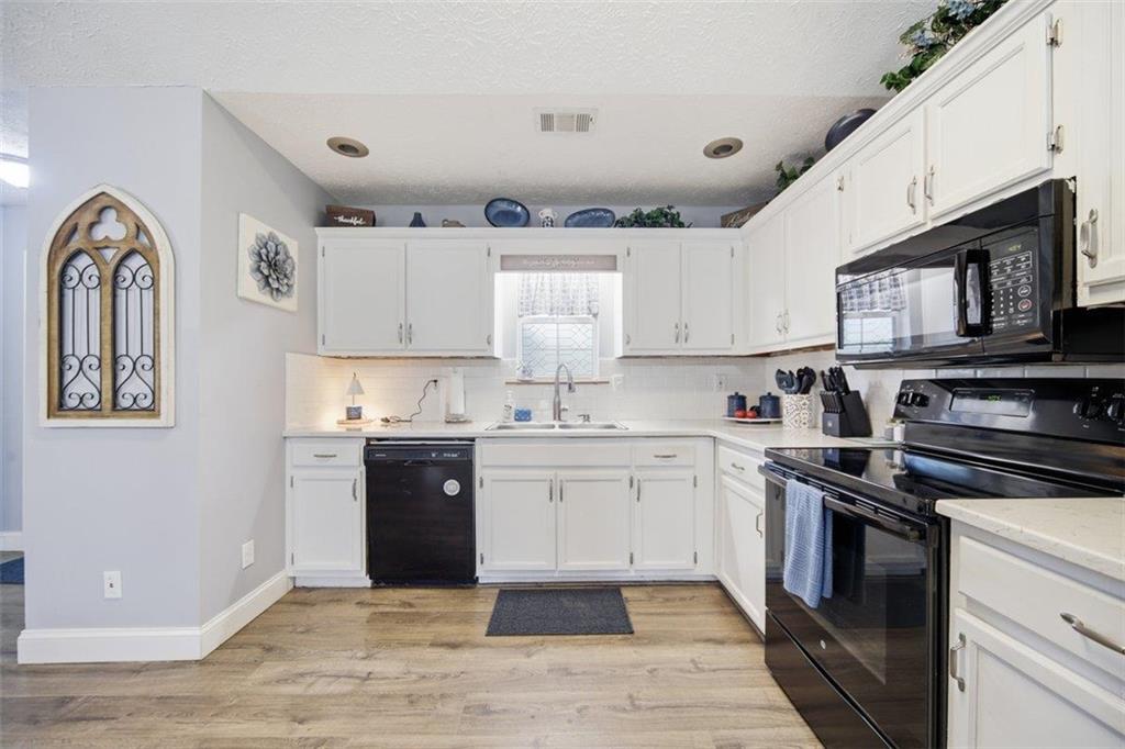 10 Stoneview Circle Covington, GA 30016 - Photo 7 of 25 a kitchen with stainless steel appliances granite countertop a stove a sink and a microwave