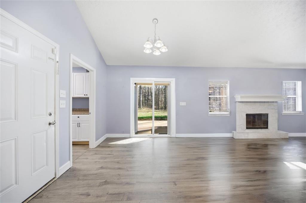 10 Stoneview Circle Covington, GA 30016 - Photo 8 of 25 a view of an empty room with wooden floor and a window
