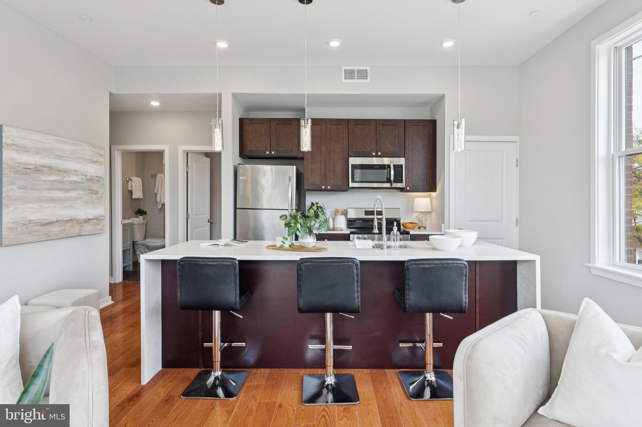a kitchen with a sink cabinets and window in it