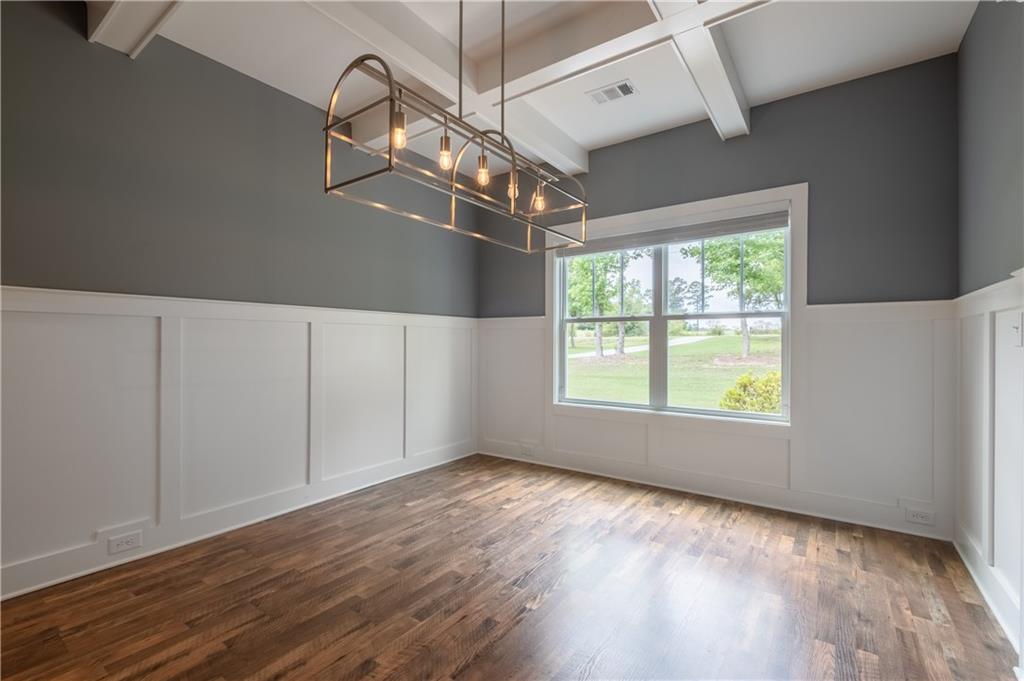 719 Fairview Road Brooks, GA 30205 - Photo 10 of 35 a view of an empty room with wooden floor and windows
