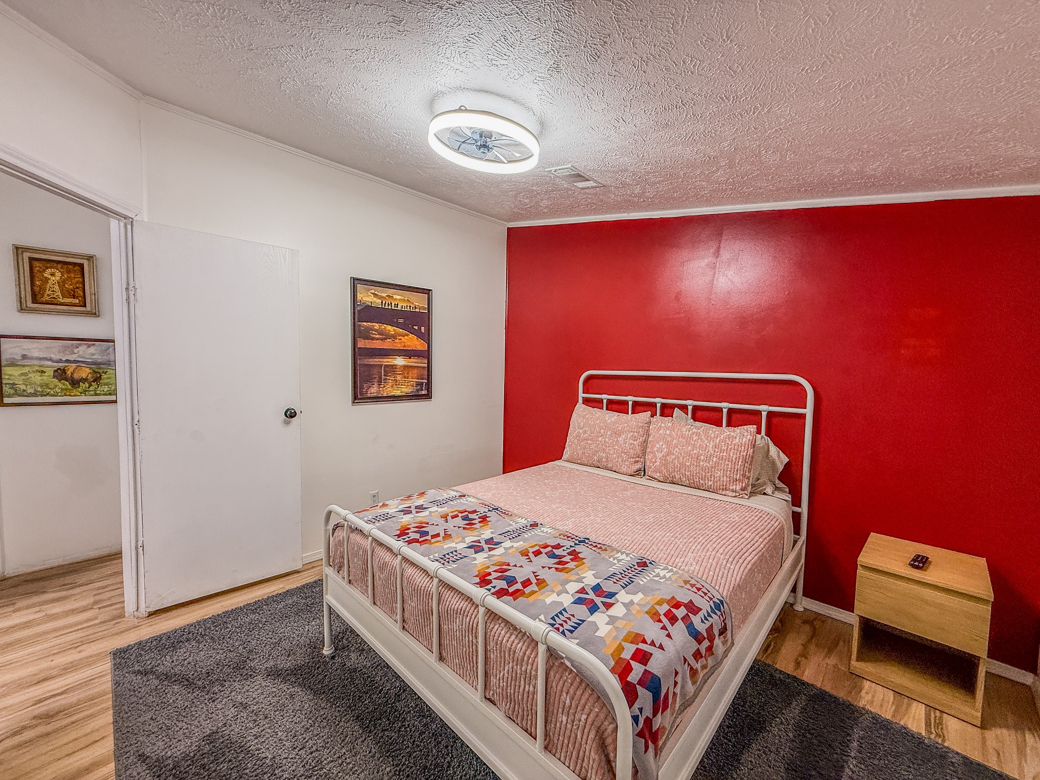 2015 Holly Street Austin, TX 78702 - Photo 8 of 24 Bold red accent wall creates a striking focal point in this inviting bedroom.