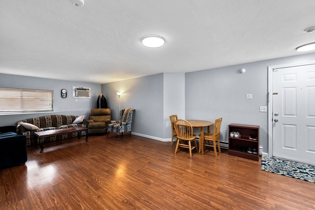 11 Gibbs Street, Unit C40 Worcester, MA 01607 - Photo 12 of 21 a living room with furniture and wooden floor
