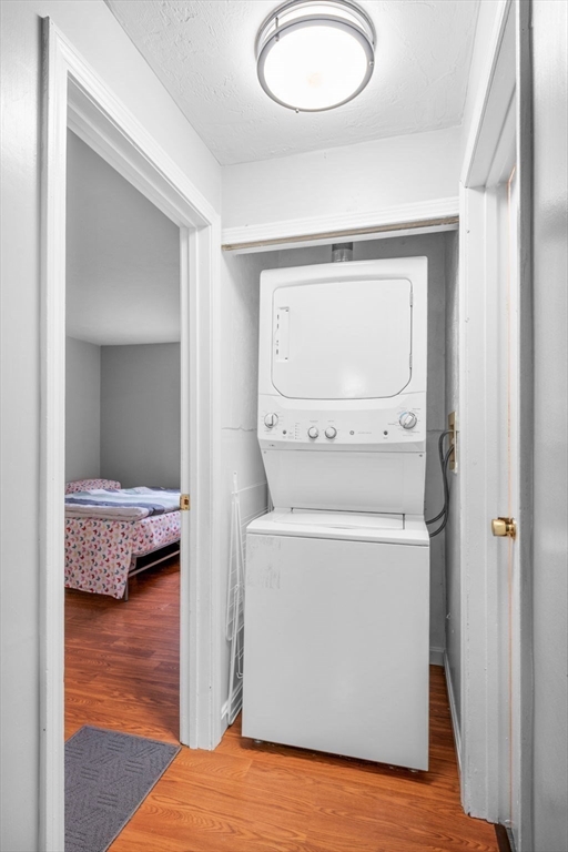 11 Gibbs Street, Unit C40 Worcester, MA 01607 - Photo 14 of 21 a bedroom with a bed and a chandelier