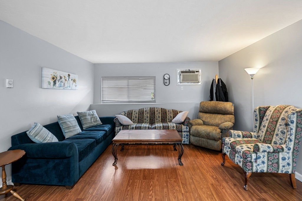 11 Gibbs Street, Unit C40 Worcester, MA 01607 - Photo 16 of 21 a living room with furniture and wooden floor