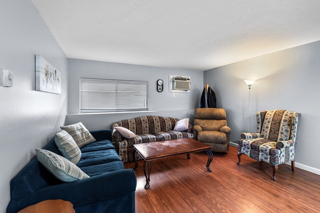 11 Gibbs Street, Unit C40 Worcester, MA 01607 - Photo 18 of 21 a living room with furniture and wooden floor