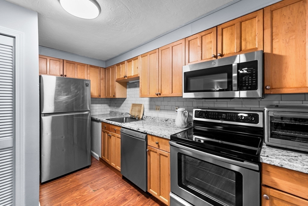 11 Gibbs Street, Unit C40 Worcester, MA 01607 - Photo 2 of 21 a kitchen with a refrigerator stove and microwave