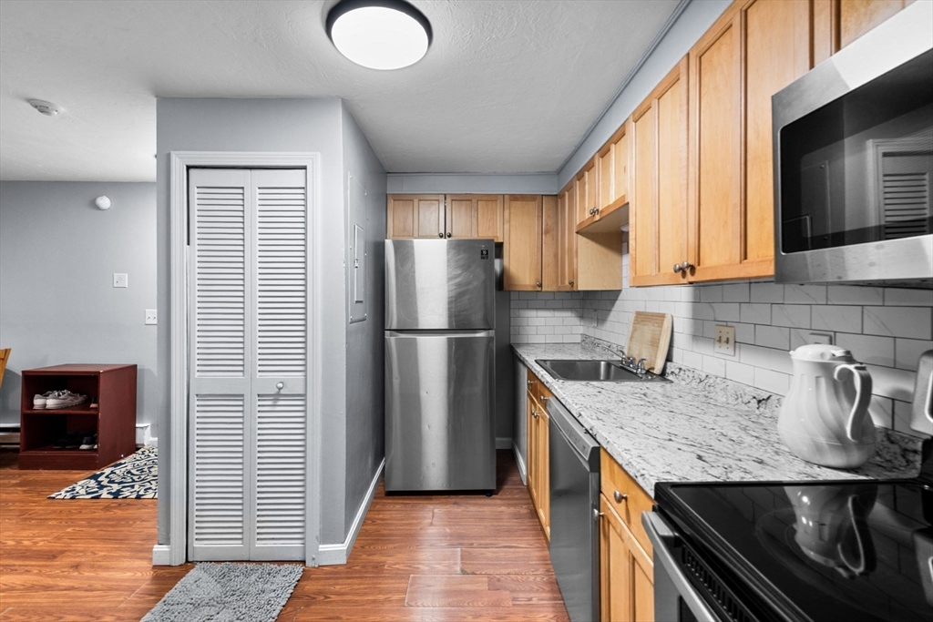 11 Gibbs Street, Unit C40 Worcester, MA 01607 - Photo 9 of 21 a kitchen with stainless steel appliances granite countertop a refrigerator a sink and a stove