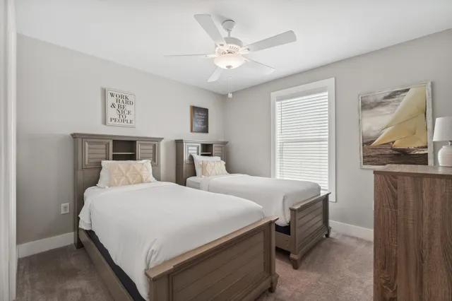 a bedroom with a large bed and a ceiling fan