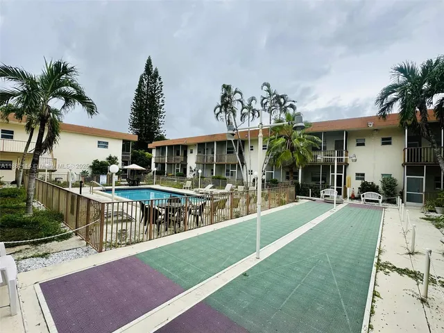 a view of a house with a swimming pool and sitting area