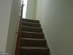 a view of staircase with white walls