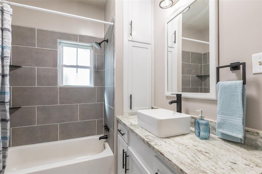 601 North Ave G Haskell, TX 79521 - Photo 30 of 36 a bathroom with a granite countertop tub sink and a mirror