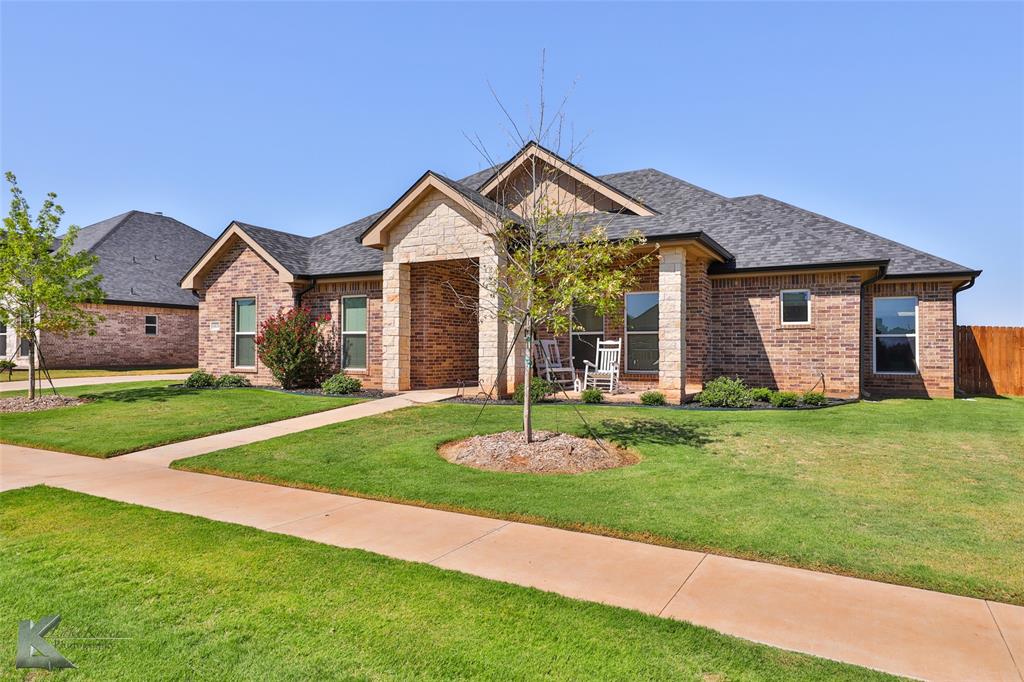 View of front of house featuring a front yard where trees were planted