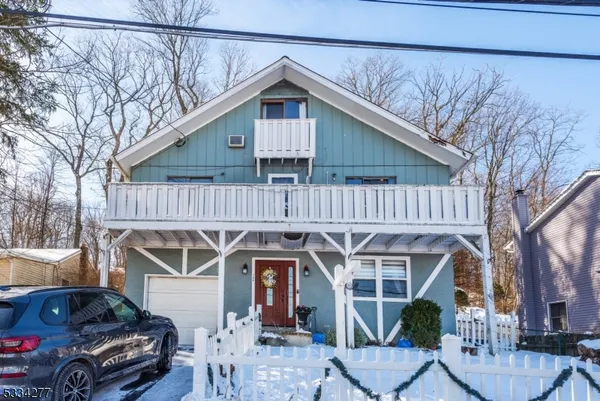 a front view of a house with parking area