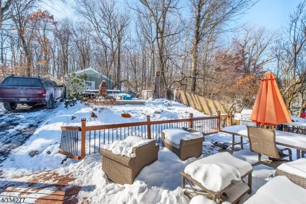 a backyard of a house with barbeque oven and wooden fence