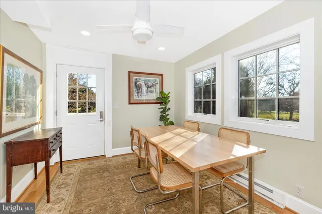 a living room with furniture a window and a refrigerator