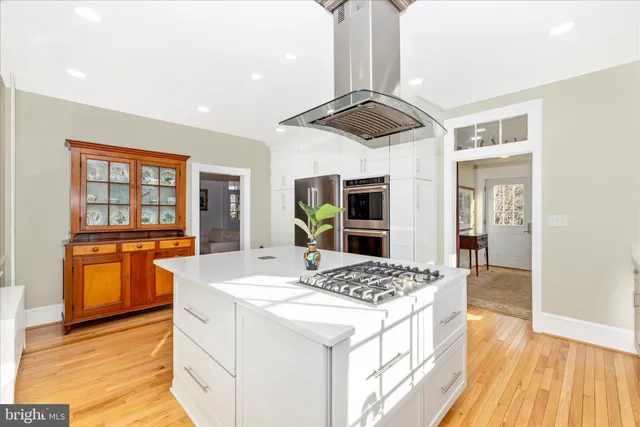 a kitchen with stainless steel appliances a refrigerator sink and microwave