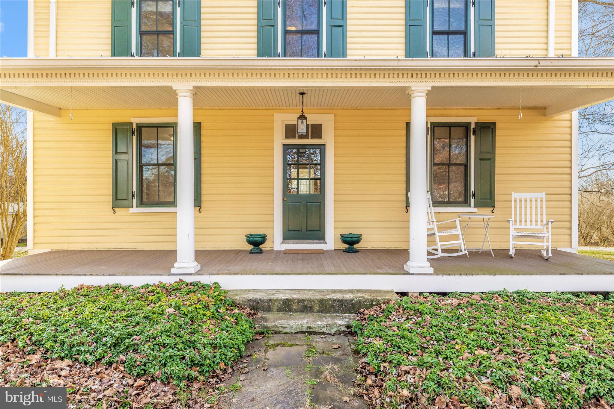 22170 Dickerson School Road Dickerson, MD 20842 - Photo 2 of 64 front view of a brick house with a large window and potted plants