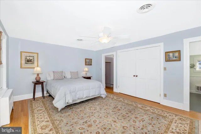 a spacious bedroom with a bed and a chandelier