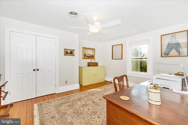 a workspace room with furniture and window