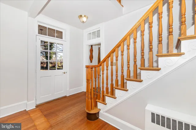 a view of entryway with wooden floor and stairs