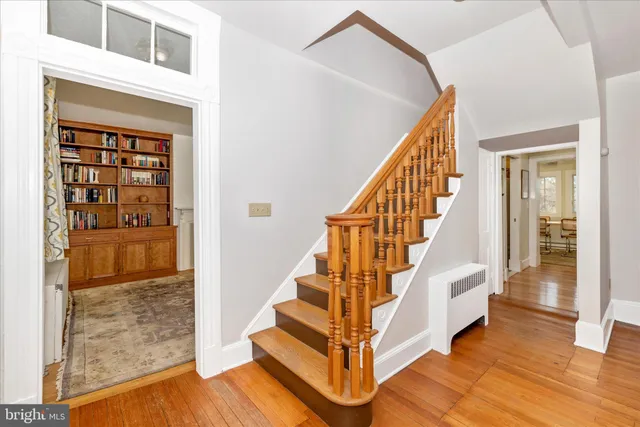 a view of entryway and hall with wooden floor
