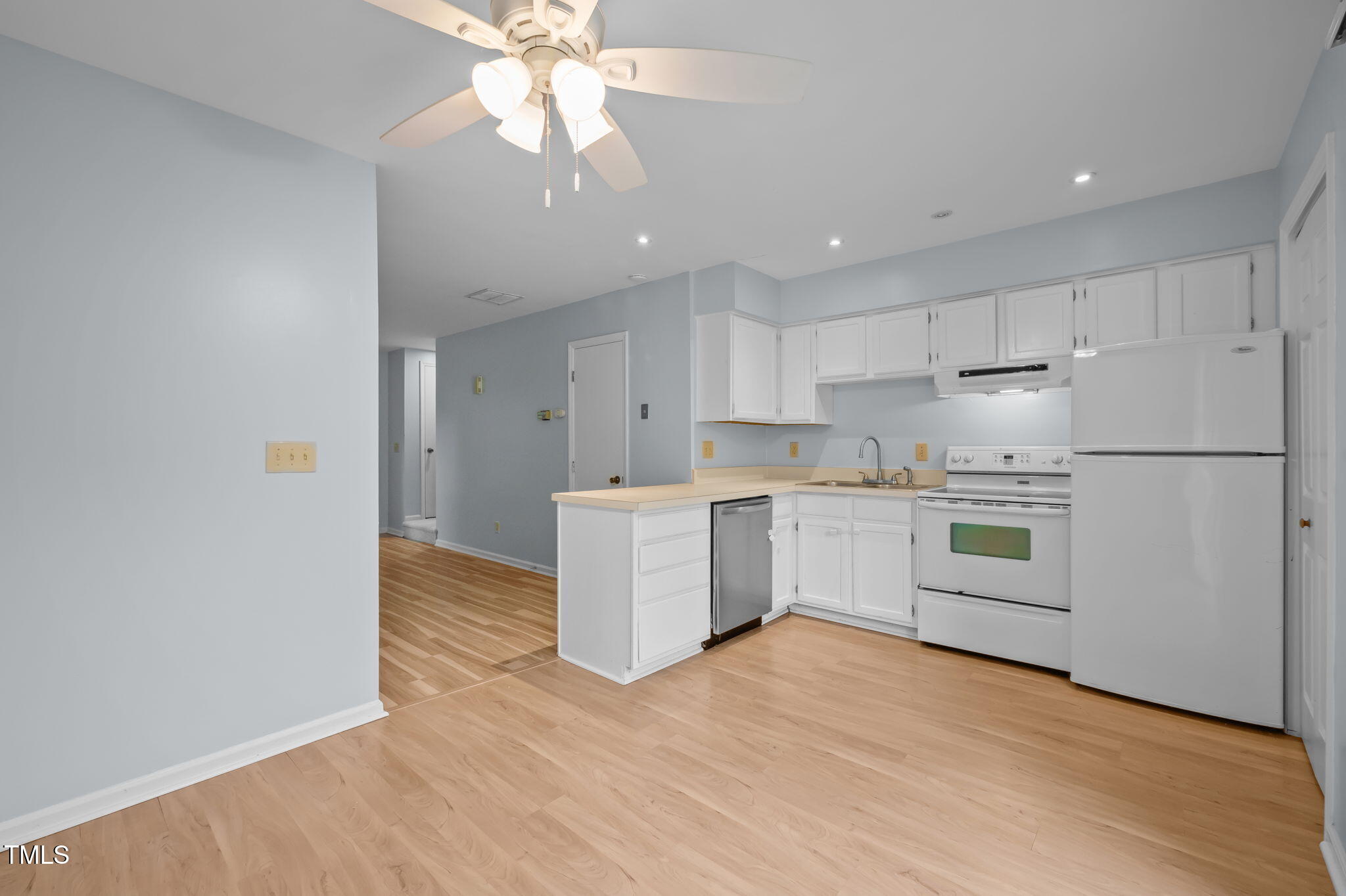 115 Coleridge Court Carrboro, NC 27510 - Photo 11 of 33 a kitchen with stainless steel appliances white cabinets and wooden floor