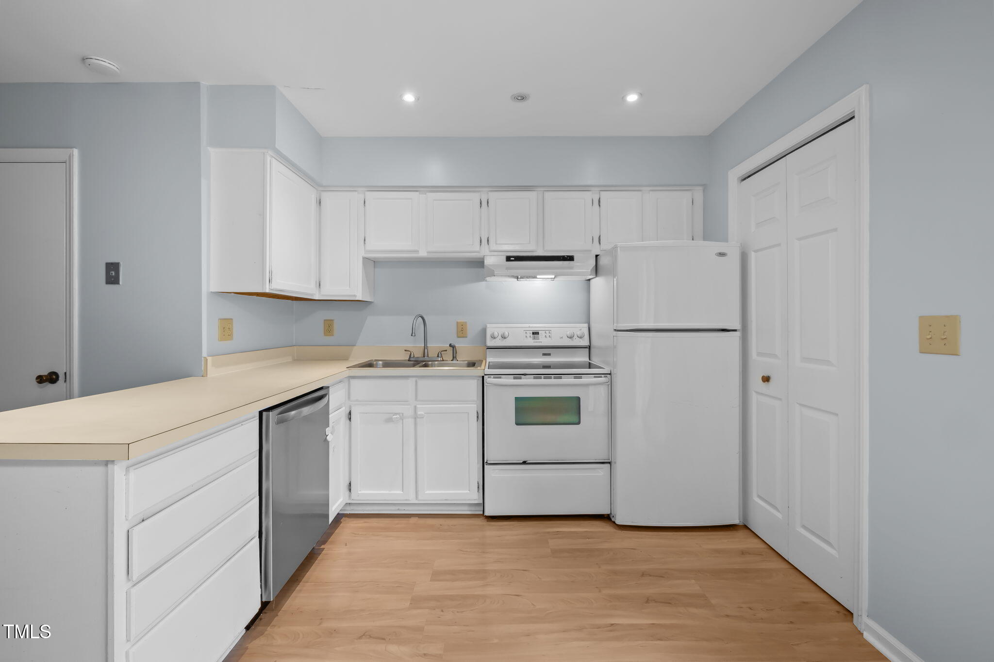 115 Coleridge Court Carrboro, NC 27510 - Photo 12 of 33 a kitchen with white cabinets and white appliances