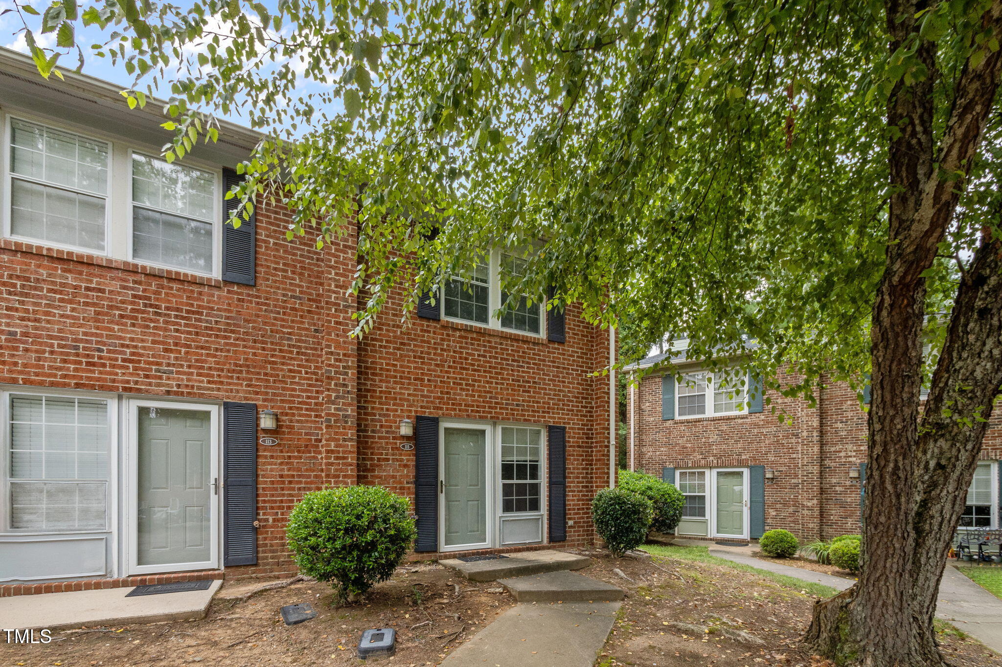 115 Coleridge Court Carrboro, NC 27510 - Photo 4 of 33 a front view of a house with a garden