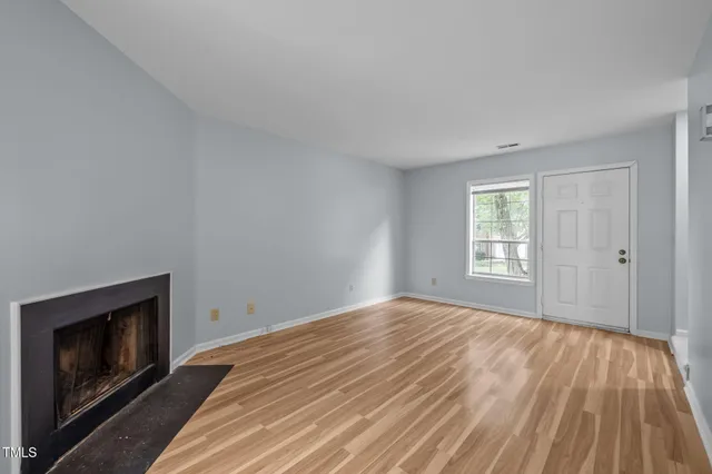 a view of a kitchen with a sink and a fireplace