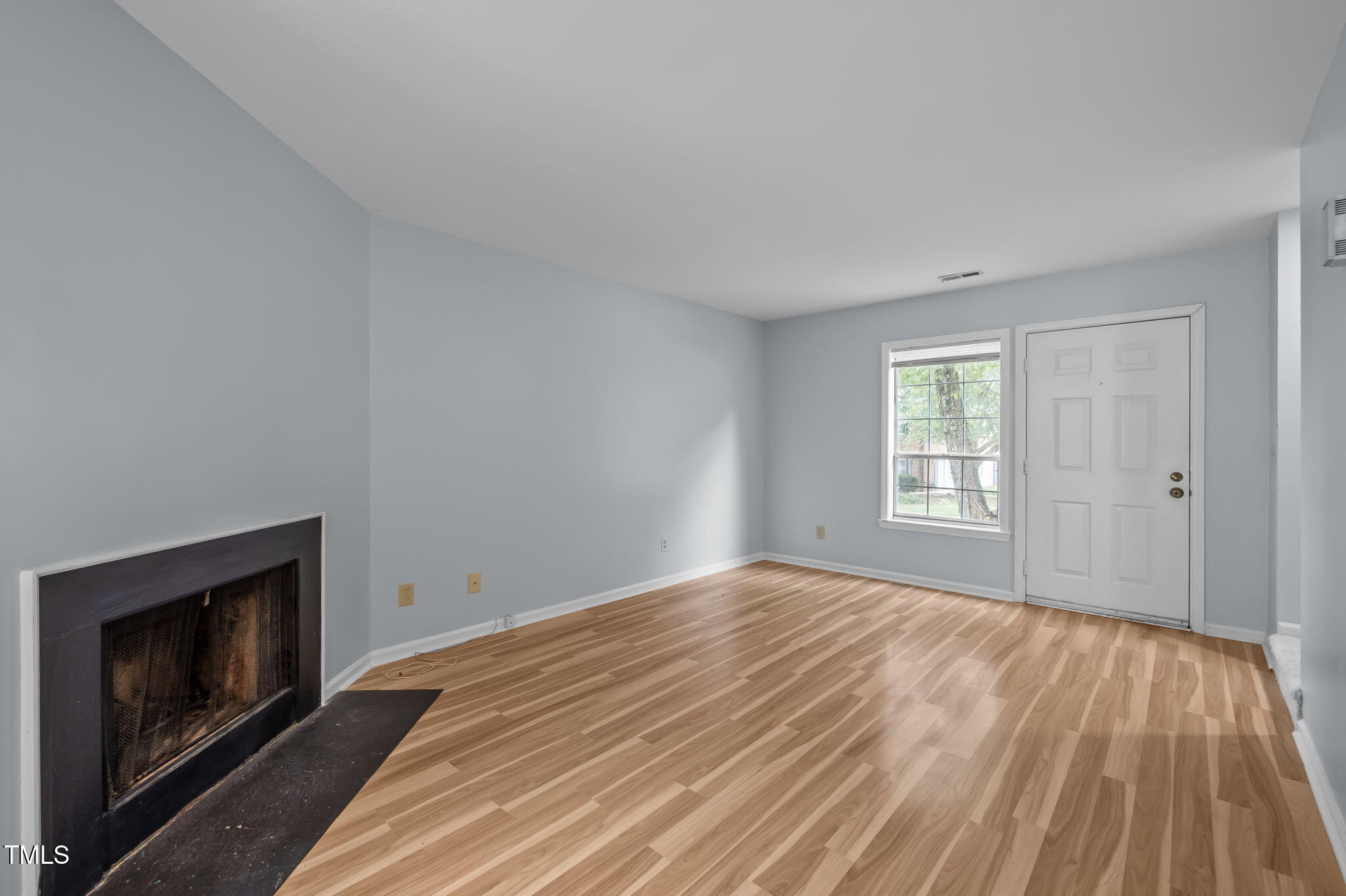 115 Coleridge Court Carrboro, NC 27510 - Photo 9 of 33 a view of empty room with wooden floor and fireplace