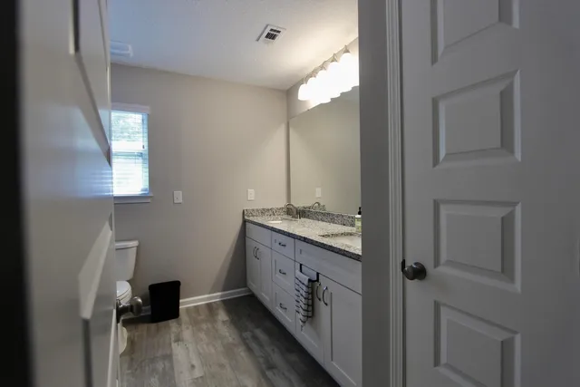 a bathroom with a double vanity sink and a mirror