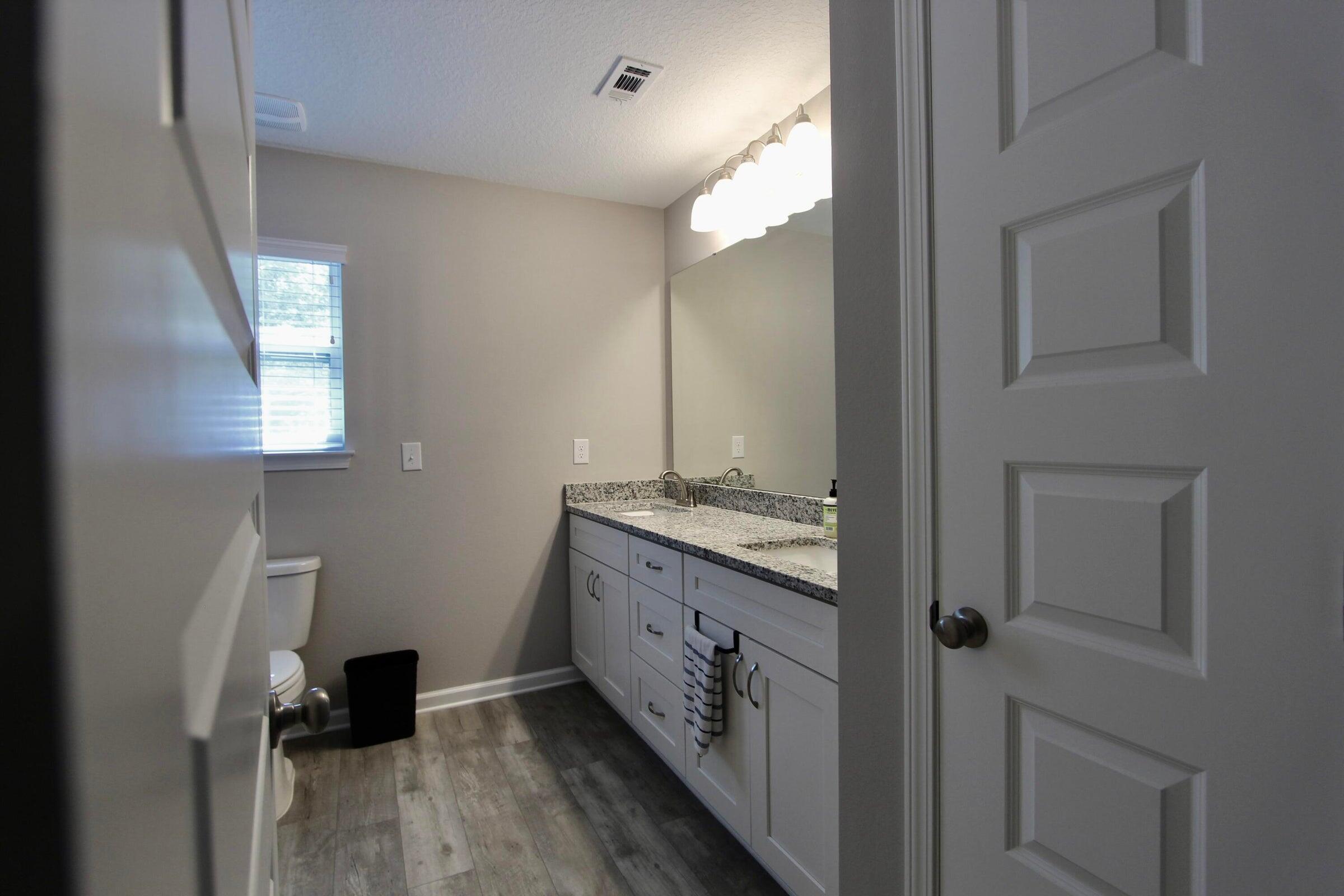 102 Windsor Drive Crestview, FL 32539 - Photo 18 of 25 a bathroom with a double vanity sink and a mirror