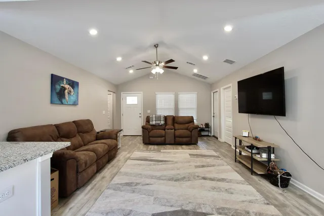 a living room with furniture and a flat screen tv