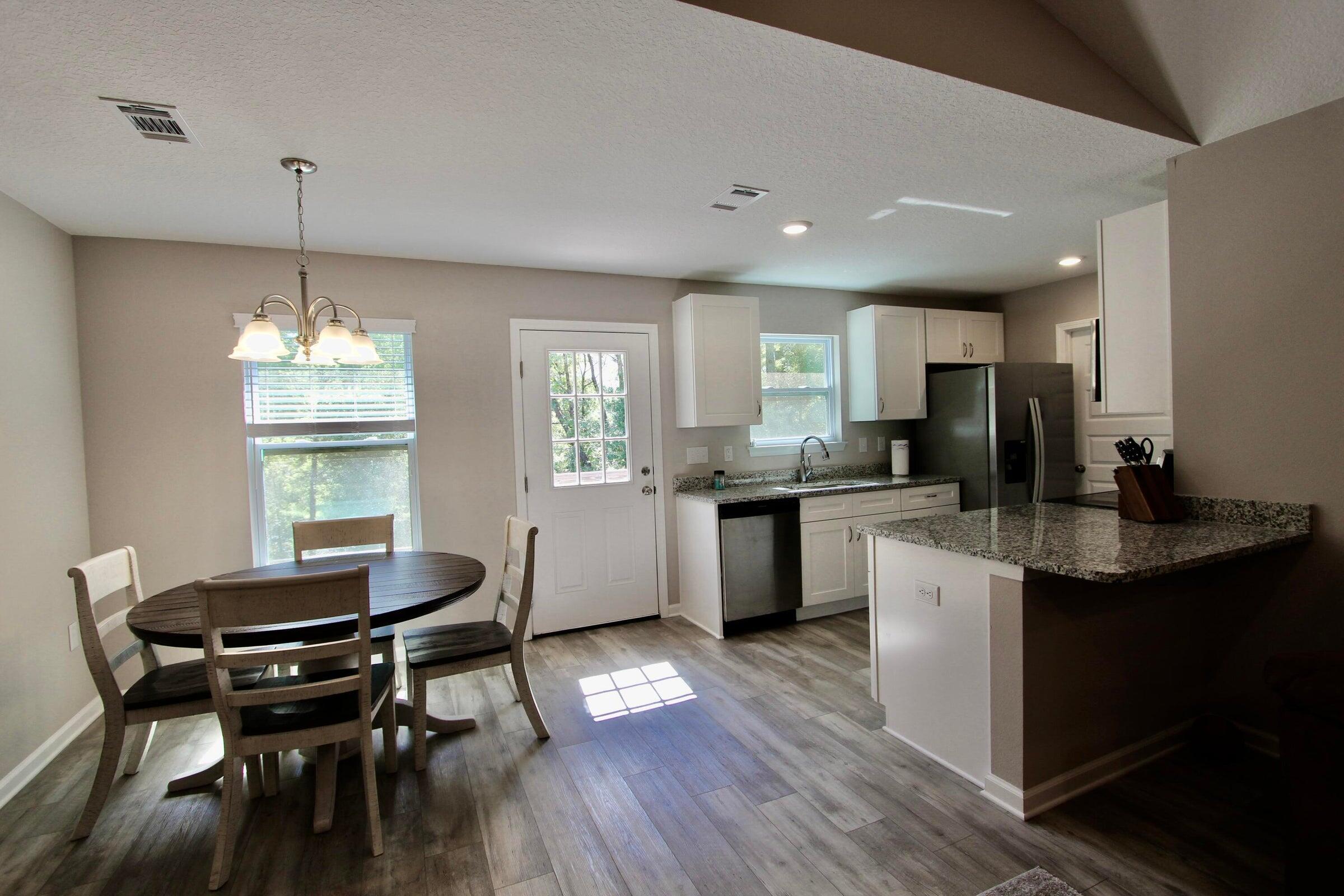 102 Windsor Drive Crestview, FL 32539 - Photo 10 of 25 a kitchen with a dining table chairs stove and cabinets