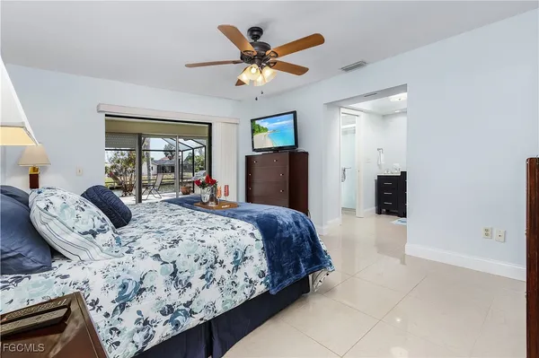 a bedroom with a large bed and a chandelier