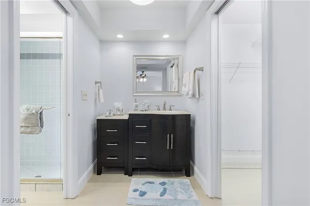 a bathroom with a sink vanity and mirror