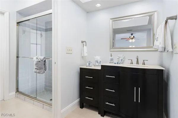 a bathroom with a sink vanity and mirror
