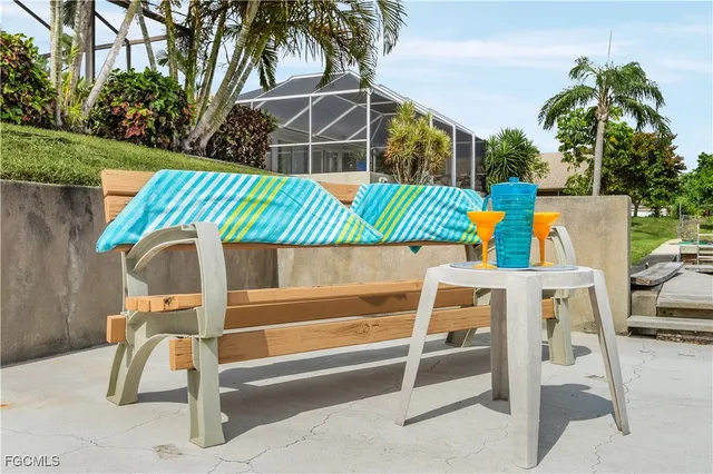 a view of a chairs and table in the backyard