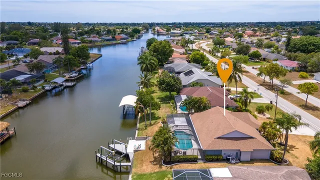 an aerial view of residential houses with outdoor space and swimming pool